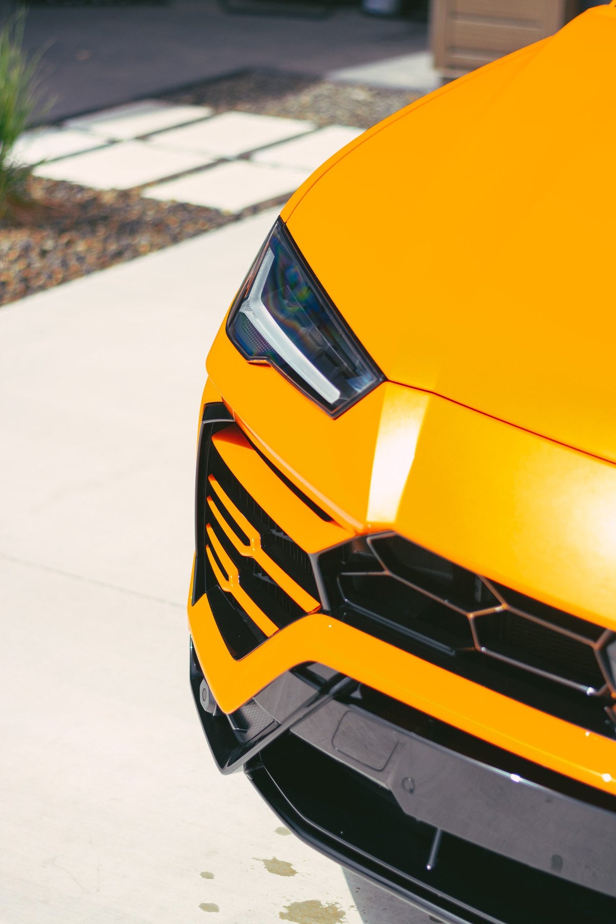 front of a orange lamborghini urus