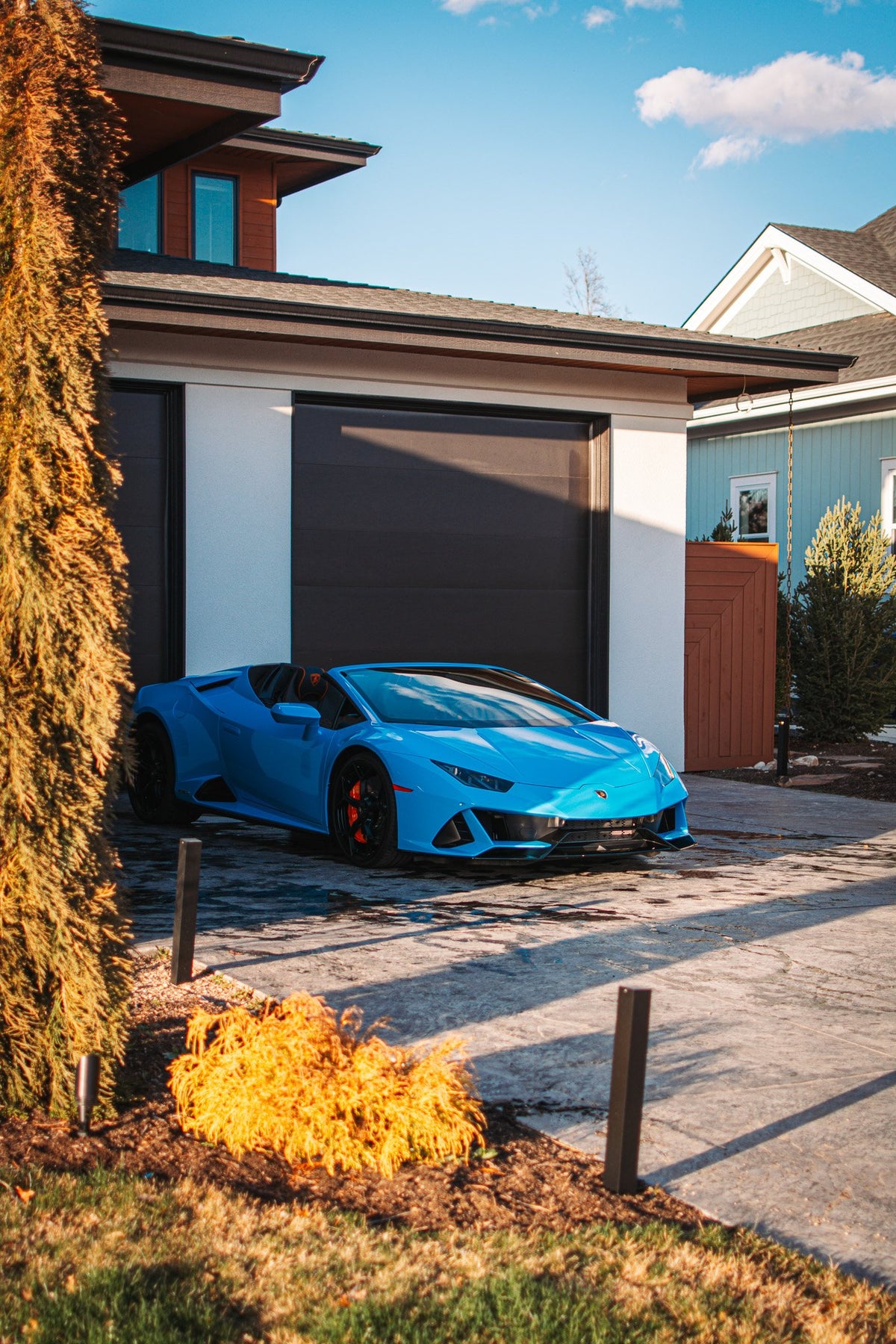 blue lamborghini parked in house driveway
